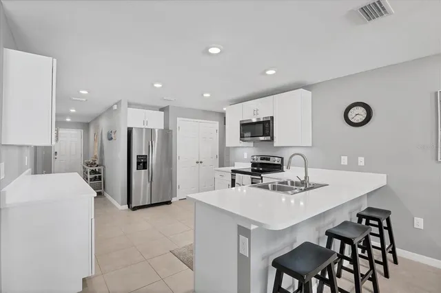 a kitchen with stainless steel appliances a refrigerator stove microwave and cabinets