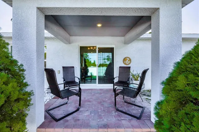 a living room with furniture and potted plants