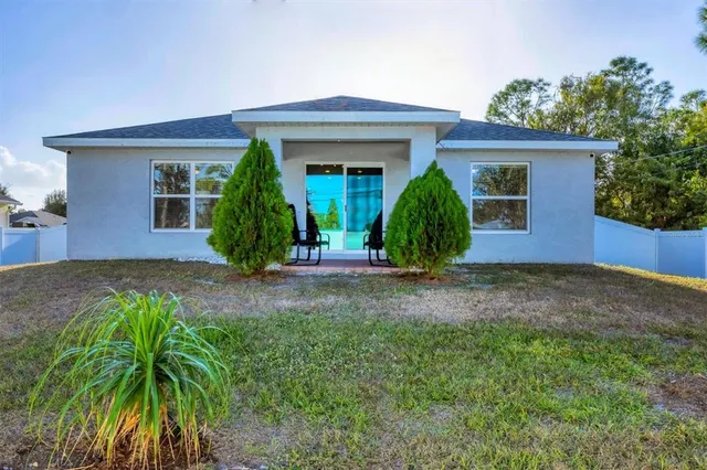 front view of a house with potted plants