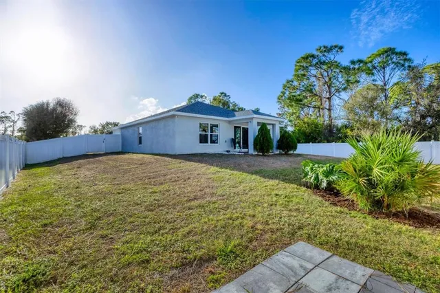 a view of a backyard with plants and a patio