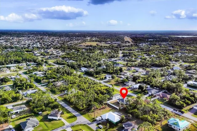 an aerial view of a houses with a yard