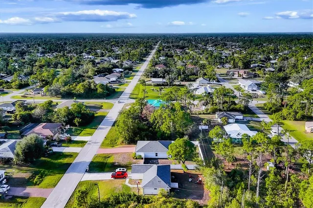 an aerial view of multiple houses with yard