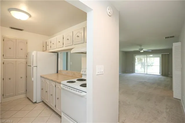 a view of a kitchen with white cabinets