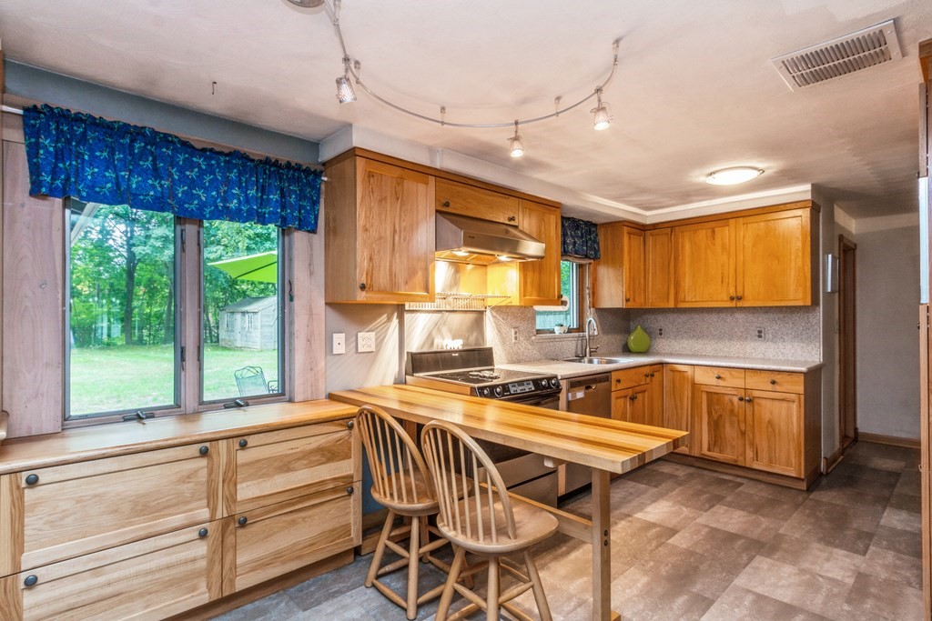 96 Simpson Drive Framingham, MA 01701 - Photo 14 of 35 a kitchen with a stove a sink and a refrigerator