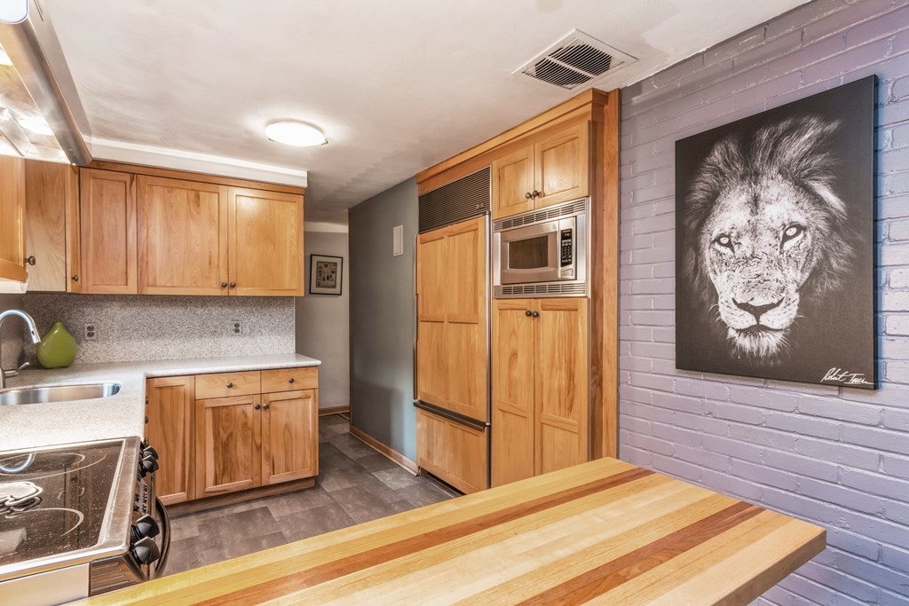 96 Simpson Drive Framingham, MA 01701 - Photo 15 of 35 a kitchen with stainless steel appliances granite countertop a refrigerator and a stove top oven