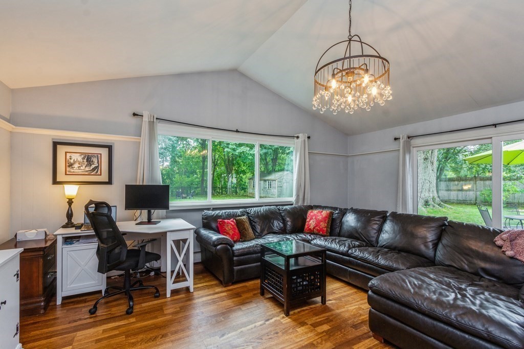 96 Simpson Drive Framingham, MA 01701 - Photo 20 of 35 a living room with furniture chandelier and a large window