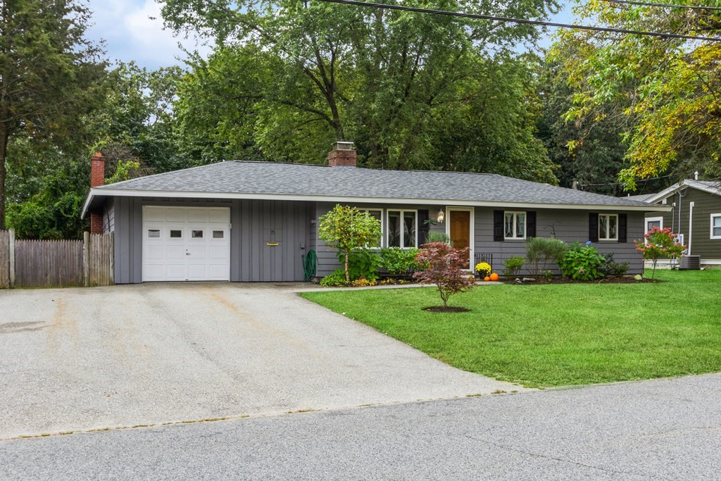 96 Simpson Drive Framingham, MA 01701 - Photo 2 of 35 a front view of a house with a yard and trees