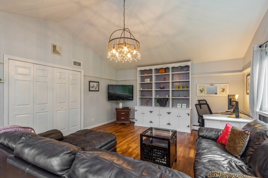 96 Simpson Drive Framingham, MA 01701 - Photo 22 of 35 a bedroom with furniture and a flat screen tv