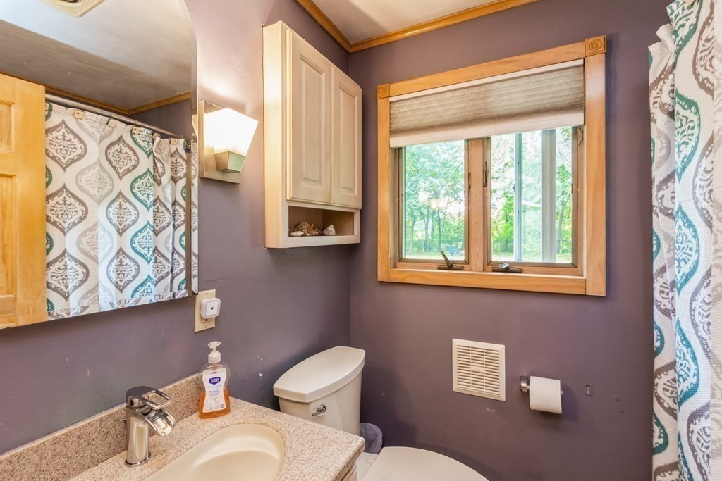 96 Simpson Drive Framingham, MA 01701 - Photo 23 of 35 a bathroom with a toilet sink and mirror