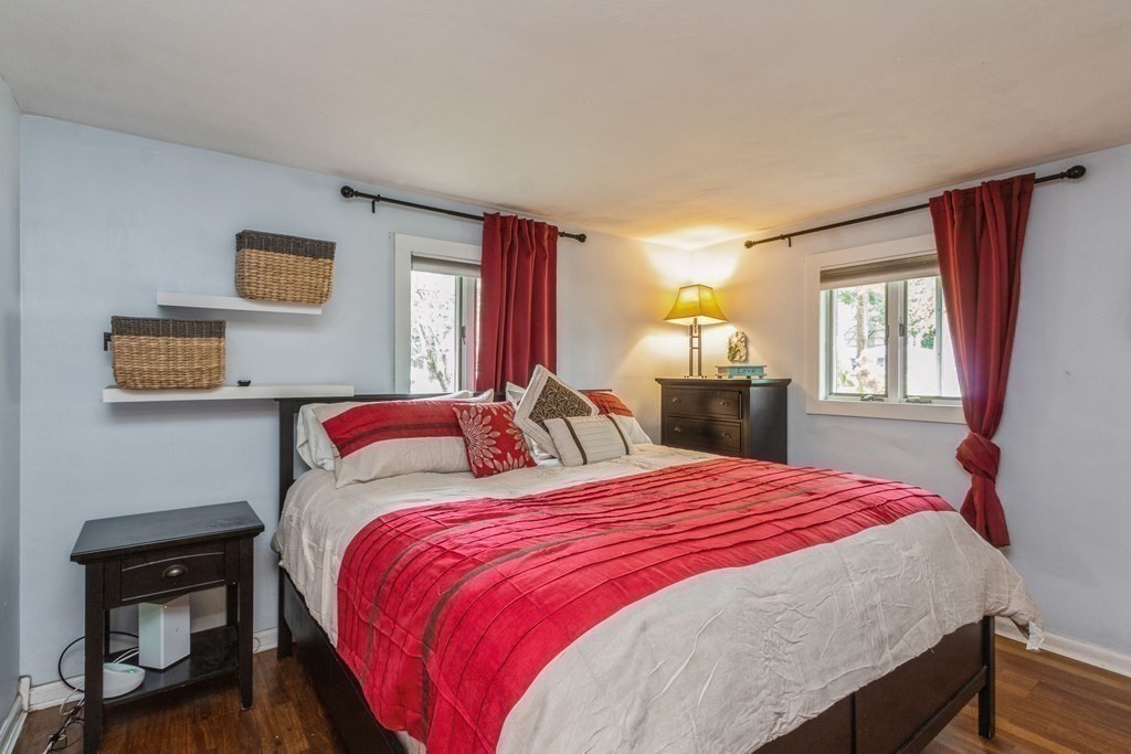 96 Simpson Drive Framingham, MA 01701 - Photo 24 of 35 a bedroom with a bed and wooden floor