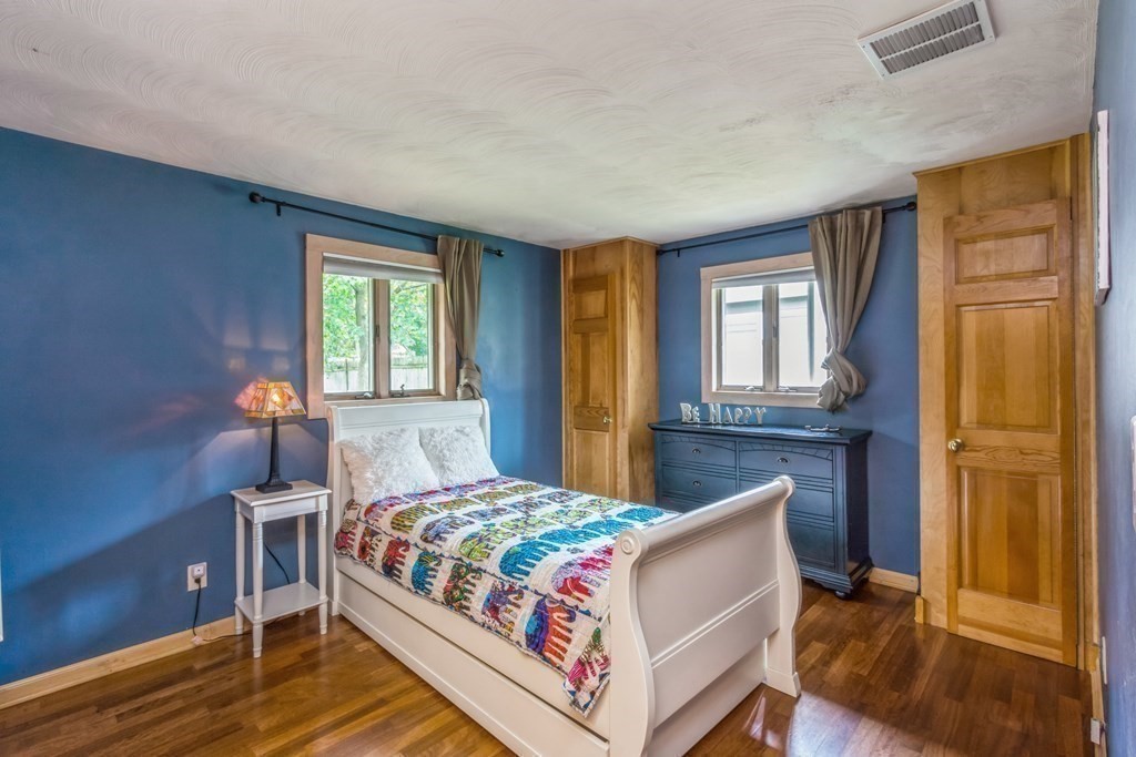 96 Simpson Drive Framingham, MA 01701 - Photo 27 of 35 a bedroom with a bed and wooden floor