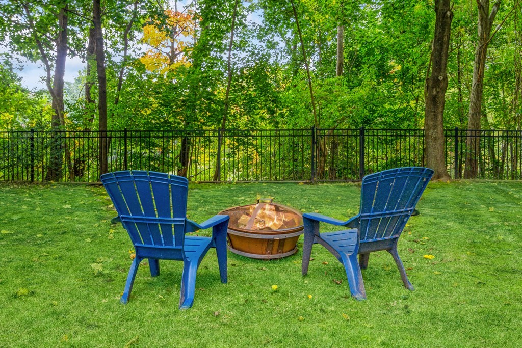 96 Simpson Drive Framingham, MA 01701 - Photo 33 of 35 a view of a chair and fire pit in the front of a big yard