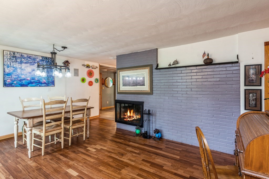 96 Simpson Drive Framingham, MA 01701 - Photo 7 of 35 a living room with furniture a fireplace and wall paintings