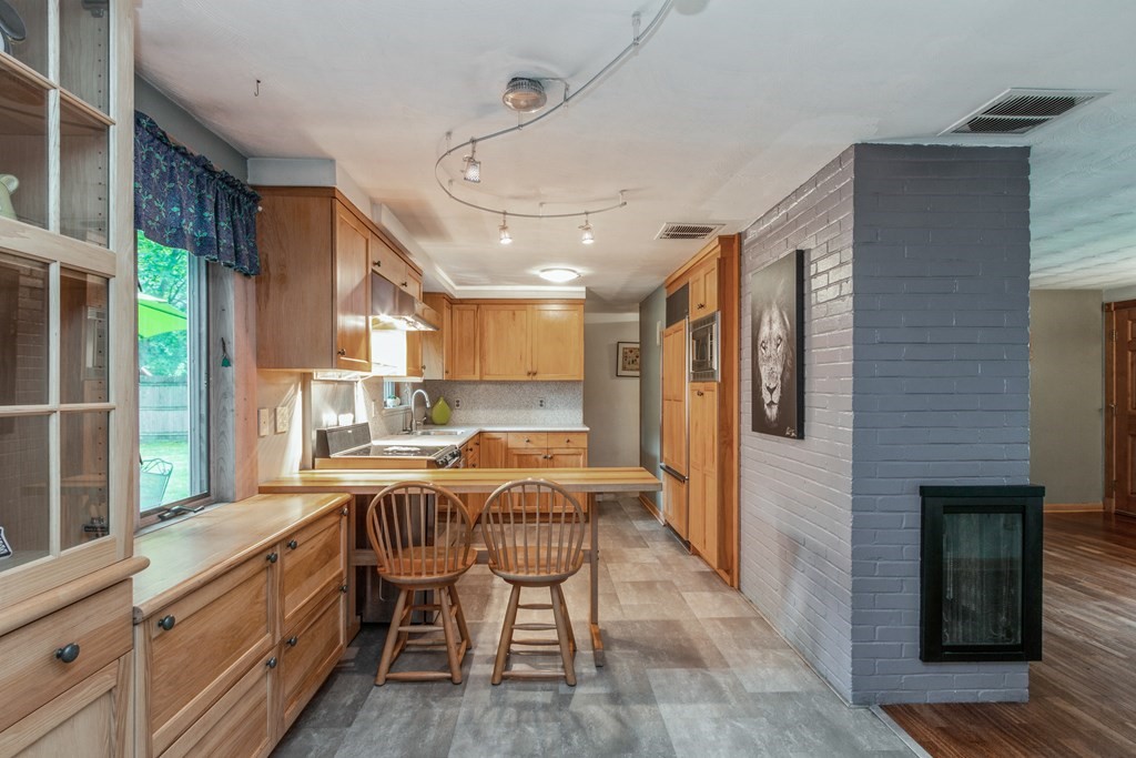 96 Simpson Drive Framingham, MA 01701 - Photo 10 of 35 a kitchen with stainless steel appliances granite countertop a kitchen island hardwood floor and a sink
