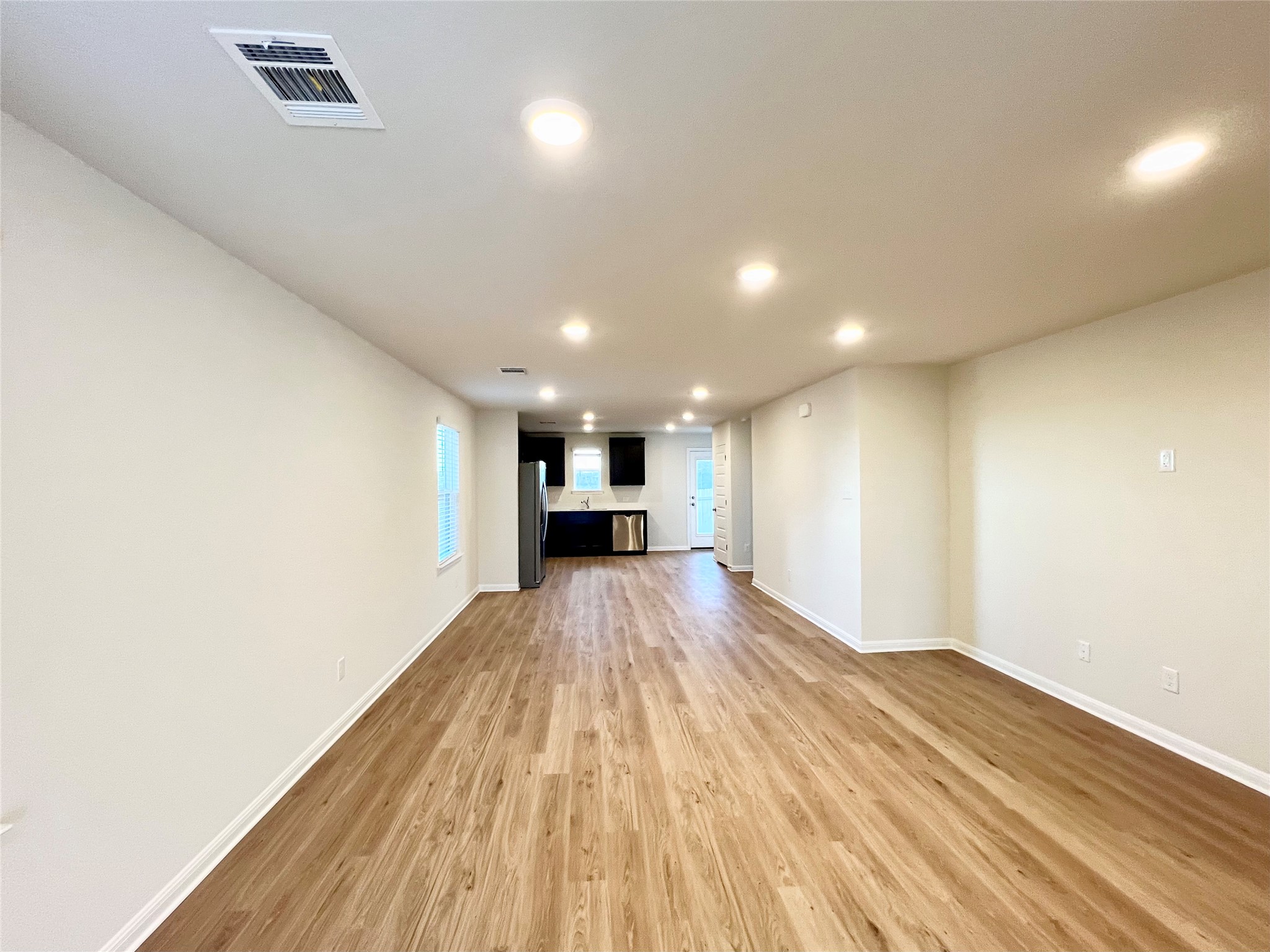 325 Alcatraz Loop Jarrell, TX 76537 - Photo 12 of 16 Unfurnished living room with light wood-type flooring and recessed lighting