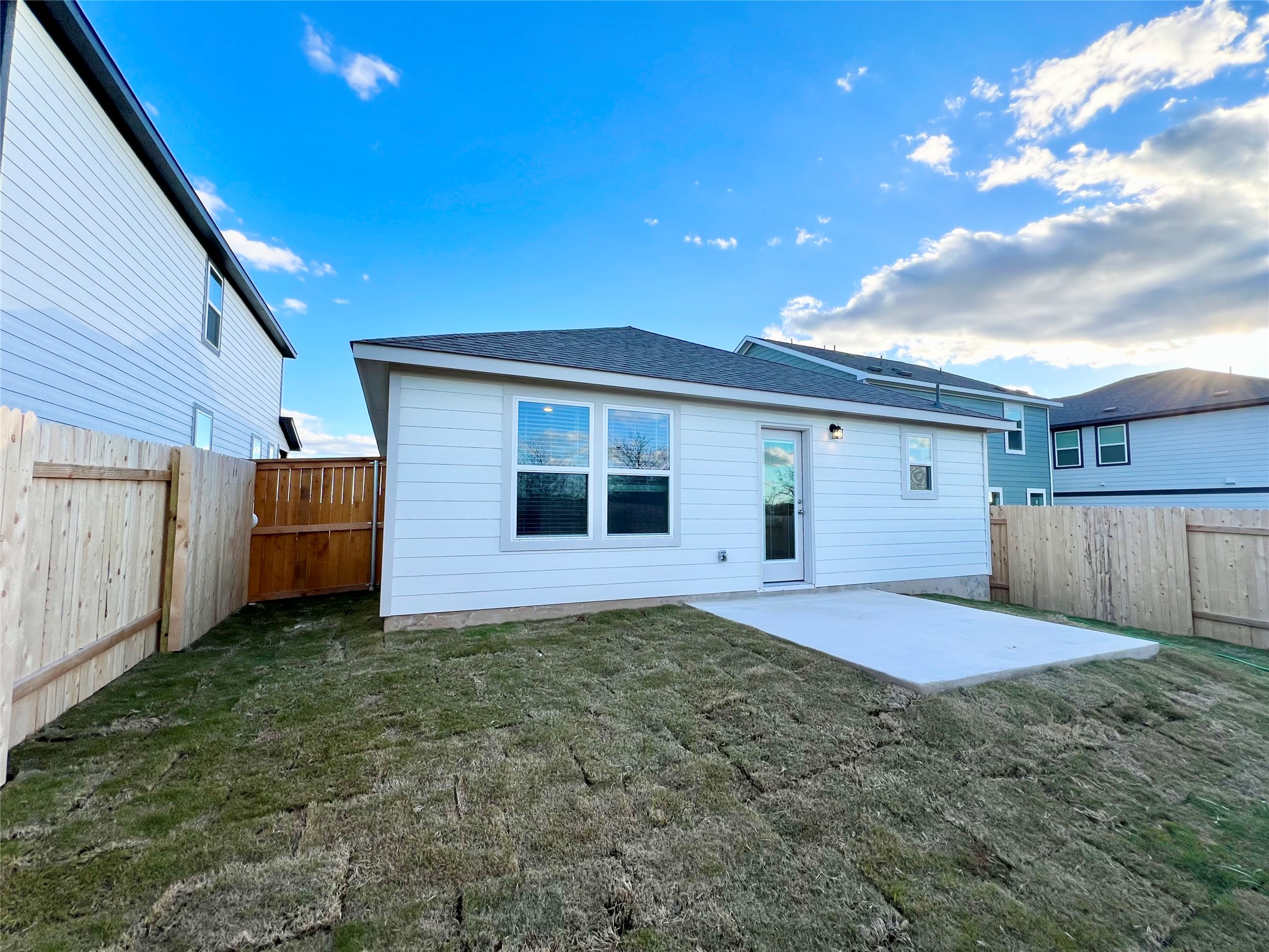 325 Alcatraz Loop Jarrell, TX 76537 - Photo 16 of 16 Back of property featuring a patio area, a fenced backyard, and roof with shingles