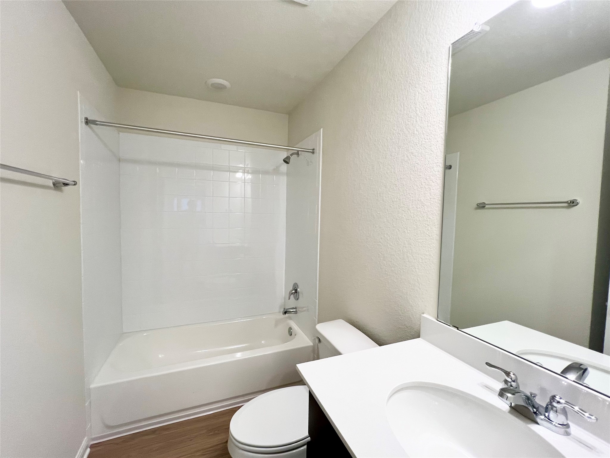 325 Alcatraz Loop Jarrell, TX 76537 - Photo 10 of 16 Full bath featuring bathtub / shower combination, a textured wall, vanity, and dark wood-style flooring
