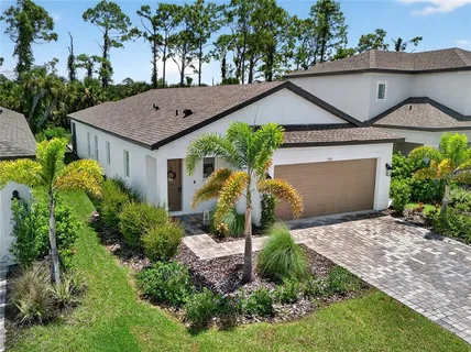 a aerial view of a house with a yard and potted plants