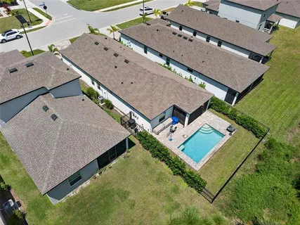 an aerial view of residential house with pool