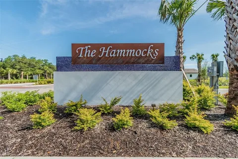 a sign that is in front of flowers