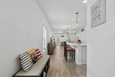 a living room with furniture and kitchen view