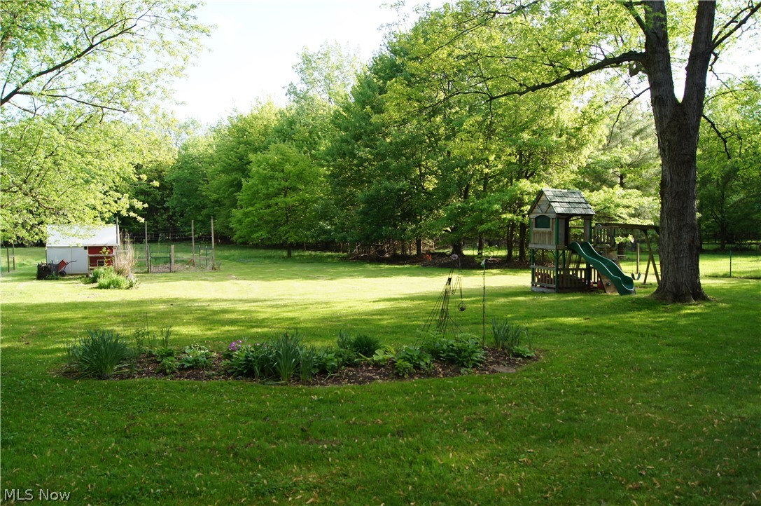 4480 Ammon Road Cleveland, OH 44143 - Photo 3 of 32 1.4 Acre yard partially fenced with fenced in garden (chicken coop does not stay)