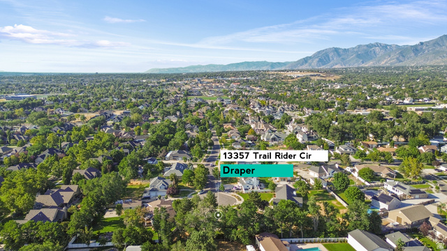 13357 Trail Rider Circle Draper, UT 84020 - Photo 70 of 70 Expansive aerial view showcasing a verdant residential area with mature trees and a distant mountain range backdrop