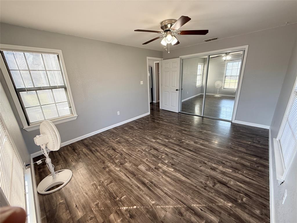1327 Old Jacksboro Road Graham, TX 76450 - Photo 14 of 33 wooden floor in an empty room with a window