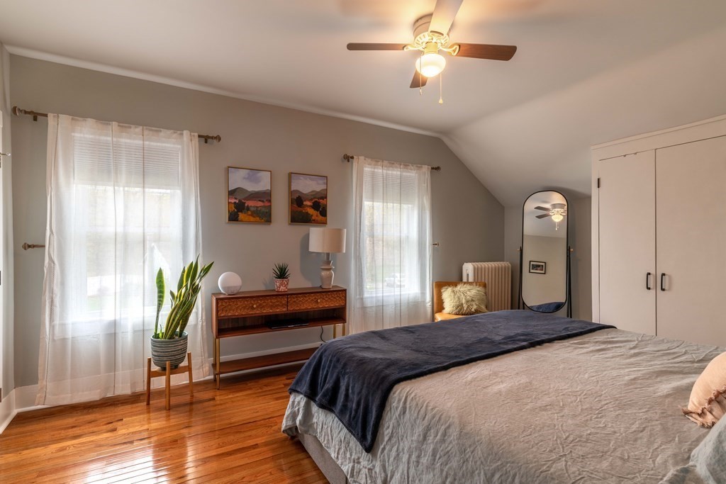 603 Spring Street Northampton, MA 01053 - Photo 34 of 38 a bedroom with a bed and a chandelier