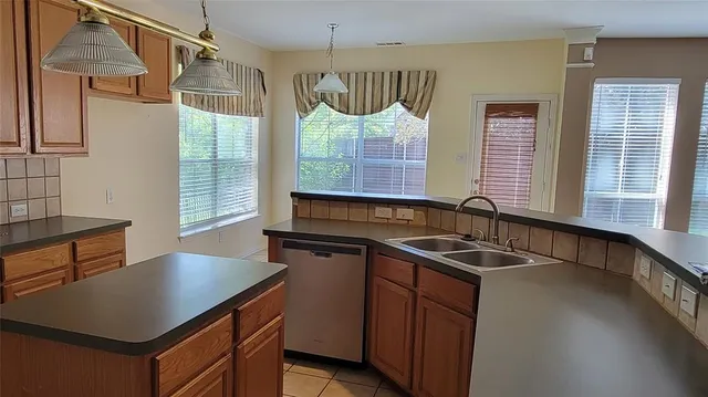 a kitchen that has a sink and a stove in it