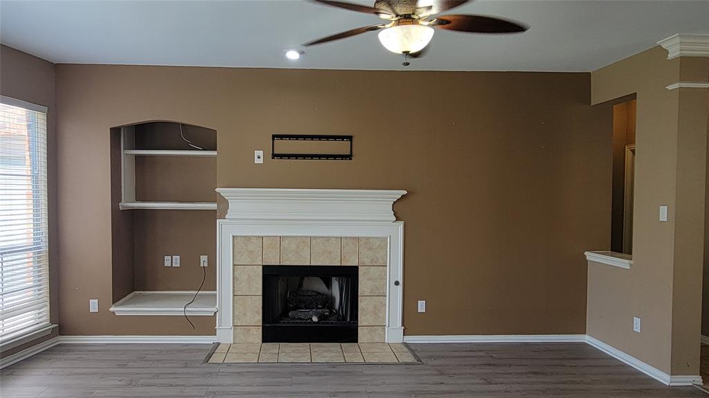 2400 Spillway Circle Frisco, TX 75036 - Photo 12 of 21 a living room with furniture and a fireplace