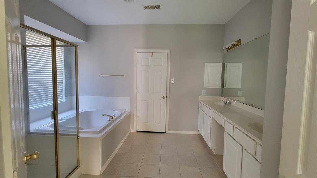 2400 Spillway Circle Frisco, TX 75036 - Photo 18 of 21 a bathroom with a tub sink and mirror
