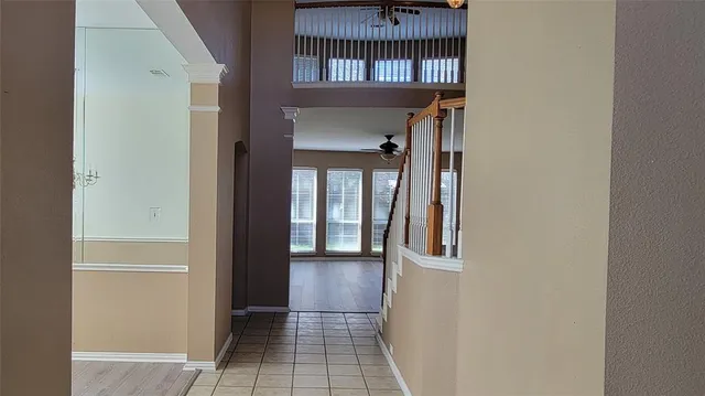 a view of a hallway with a door and wooden floor