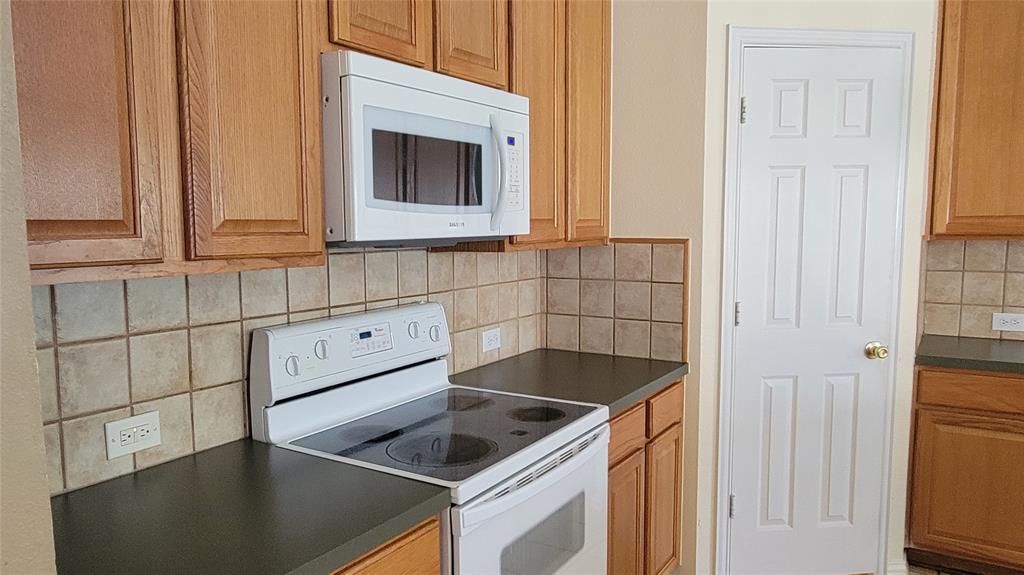 2400 Spillway Circle Frisco, TX 75036 - Photo 10 of 21 a kitchen with a sink and a stove top oven