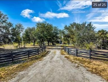 25800 Washington Street Astatula, FL 34705 - Photo 5 of 14 a view of a yard with wooden fence