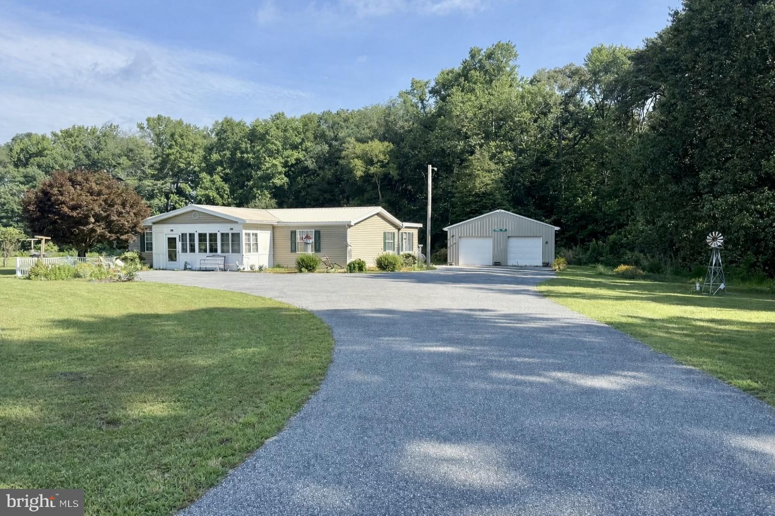 a house view with swimming pool and garden space