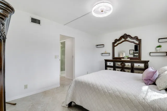 a bedroom with a bed and a chair