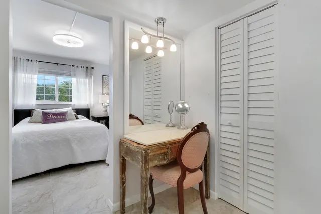 a bedroom with a bed and windows