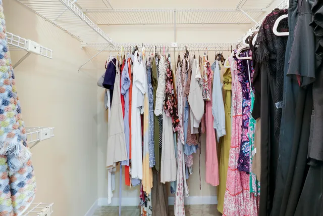 a view of walk in closet with clothes