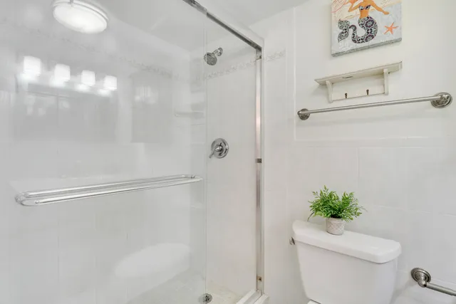 a bathroom with a shower a toilet and a shower