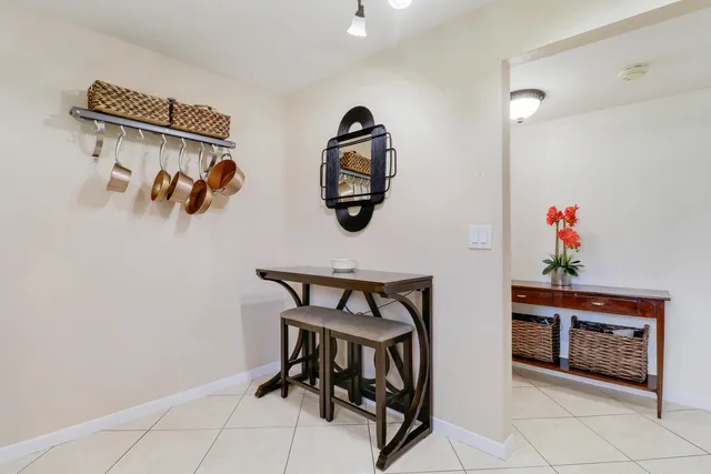 a view of dining room with baby crib and wooden floor