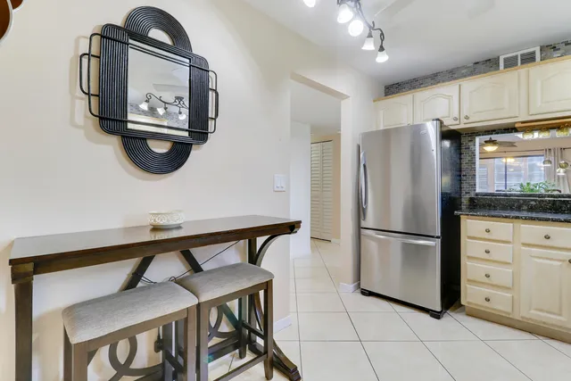 a kitchen with a refrigerator a stove a microwave and cabinets