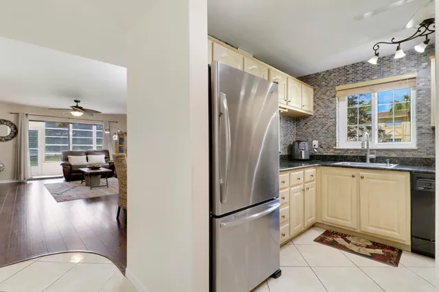 a kitchen with a refrigerator a stove and a sink