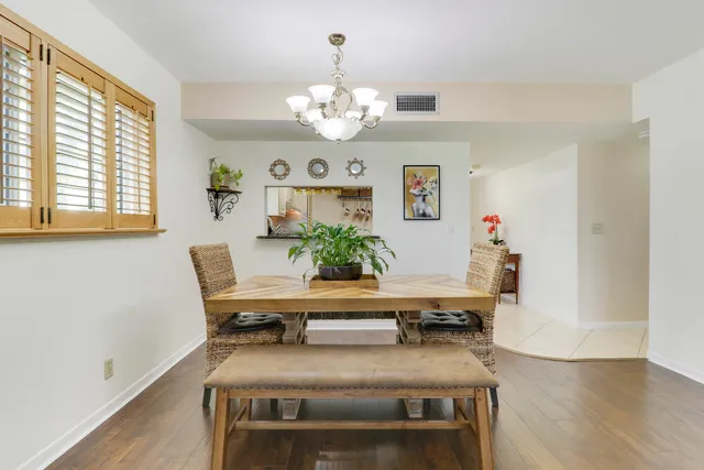 a view of a dining room with furniture and chandelier