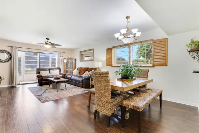 a living room with furniture dining table and a window