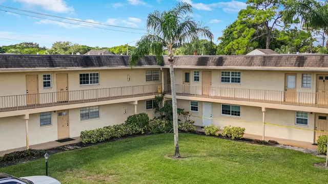 a view of a cars park in front of a building