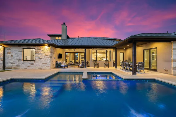 a view of a swimming pool with outdoor seating
