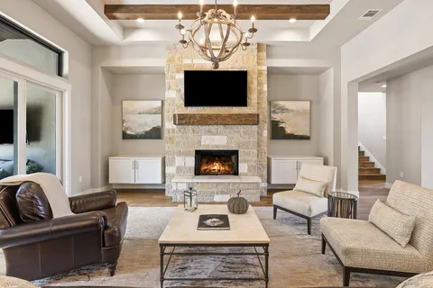 a living room with furniture a fireplace and a flat screen tv