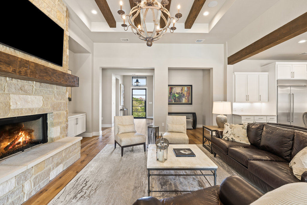 4746 R O Drive Spicewood, TX 78669 - Photo 14 of 40 a living room with furniture a flat screen tv and a fireplace