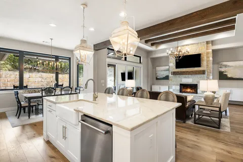 a large kitchen with a table and chairs